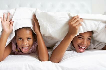 kids playing under covers at home